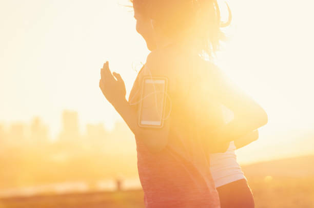 istock Two women running together in the park. 945881678