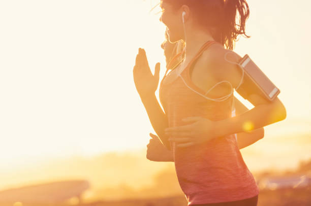 istock Two women running together in the park. 945881778