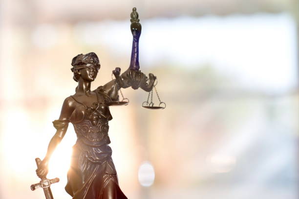 Statue of Lady Justice With Sun Rising Background stock photo