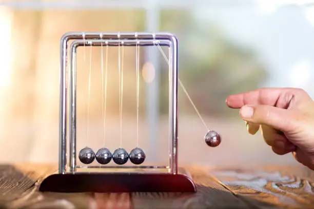 Concept For Action and Reaction or Cause And Result in Business With Newton's Cradle