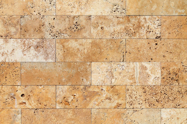 istock Natural Italian stone. Smooth travertine surface. A sample of wall cladding with natural stone. Background. 945885548