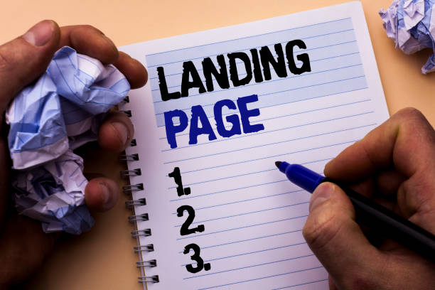 istock Handwriting text Landing Page. Concept meaning Website accessed by clicking a link on another web page written by Man on Notebook Book Holding Marker on the plain background. 945892864