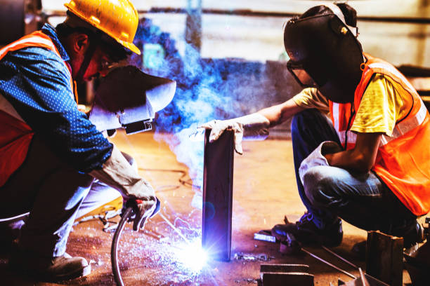 istock Cooperating to have the metal welded. 945893204
