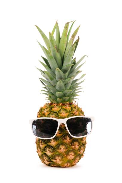 istock Hipster pineapple with sunglasses isolated on white 945895802