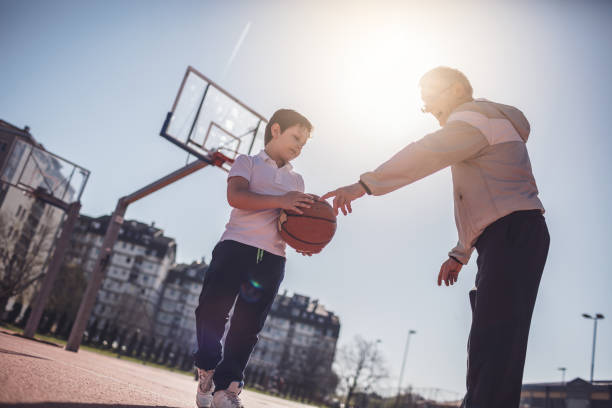 istock Grandfather And Grandson Playing Basketball 945898122