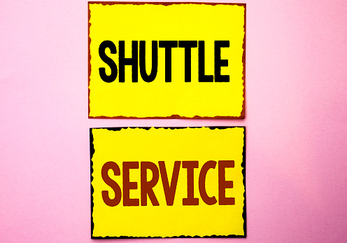 Word writing text Shuttle Service. Business concept for Transportation Offer Vacational Travel Tourism Vehicle written Yellow Sticky Notes the Pink background.