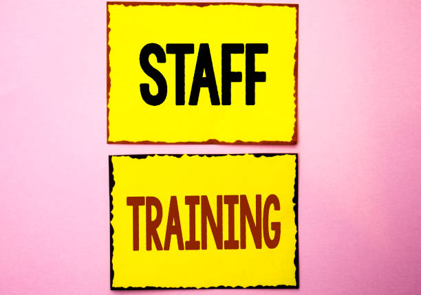 istock Word writing text Staff Training. Business concept for Teaching Teamwork new things Employee Education Preparation written on Yellow Sticky Notes on the Pink background. 945898850