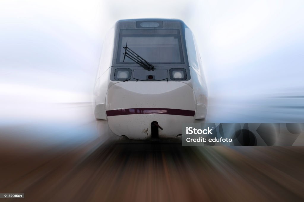 fast train passing by Front view of a passenger train approaching at full speed Front View Stock Photo