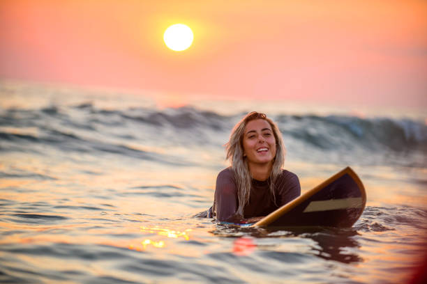 istock Female surfer floating on water 945908768