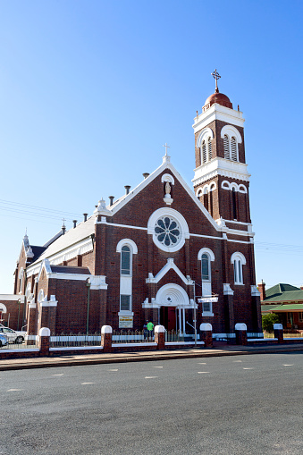View of the iconic St Mary Catholic Church, a red brick Romanesque church erected during the period of Pope Pius XI, in West Wyalong, New South Wales, Australia