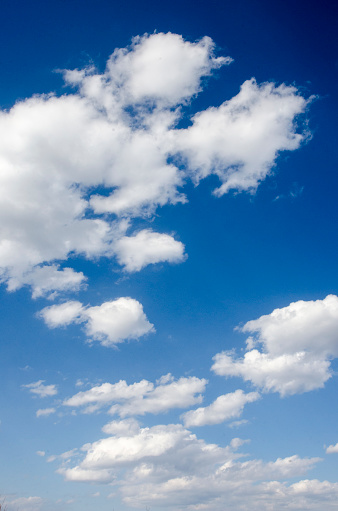 A summer sky in daytime with many clouds. Panoramic skyscape in 1:3 format.