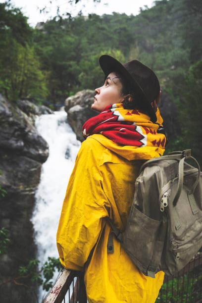 istock Solo traveler hiking in the forest, watching waterfall 945923766