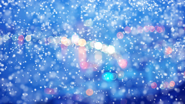 istock City light blur bokeh and Snowfall 945925302