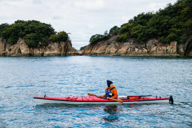 Woman exploring in a sea kayak