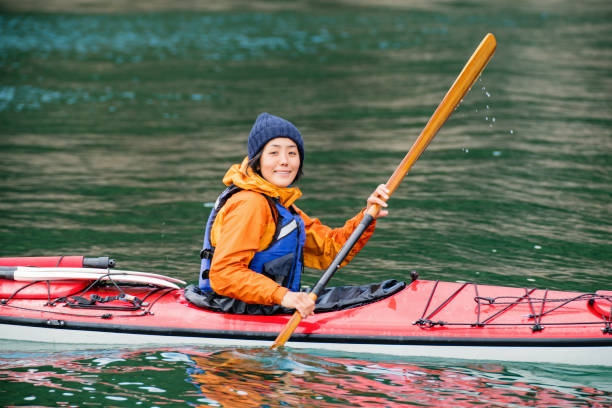istock Woman exploring in a sea kayak 945928692