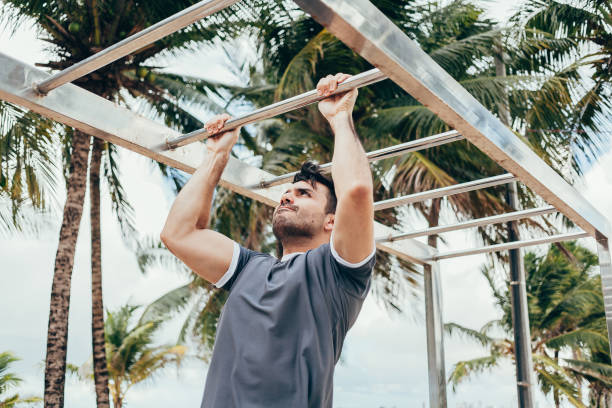istock Handsome young man doing street workout on the beach 945935512