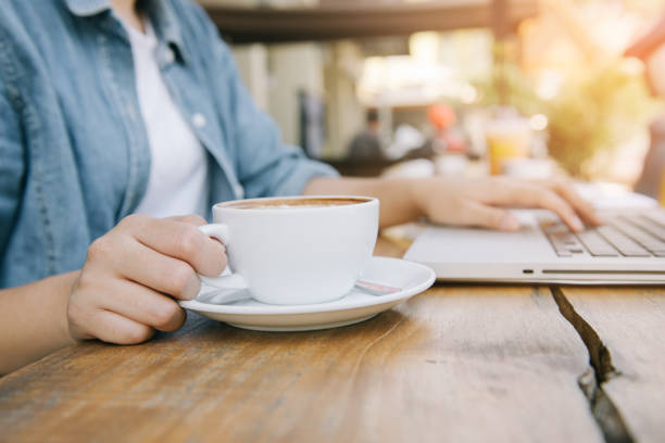 istock Beautiful hipster woman using laptop at cafe 945935536