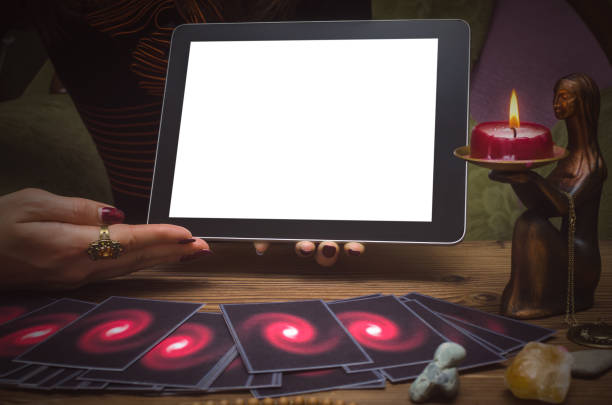 istock Tarot cards on fortune teller desk table. Online internet divination mock up. 945941912