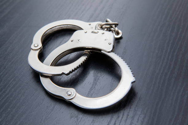 istock Silver handcuffs detaining crime prisoners 945951164