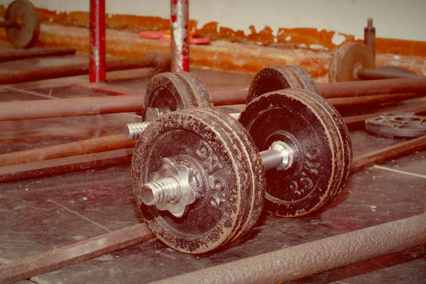 istock used adjustable dumbbells with 25 kg plates, toned in vintage colors 945968738