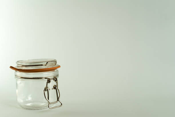 istock Glass jar for canning and preserving on white background 945968914