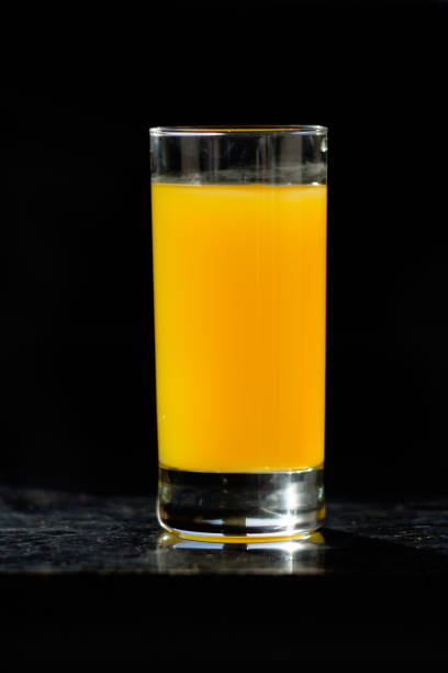 istock glass of orange juice on table in kitchen 945972532