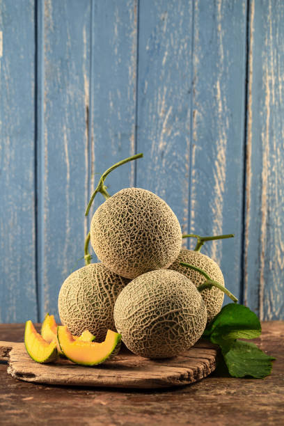 istock Close up cantaloupe melons on wooden table 945972676
