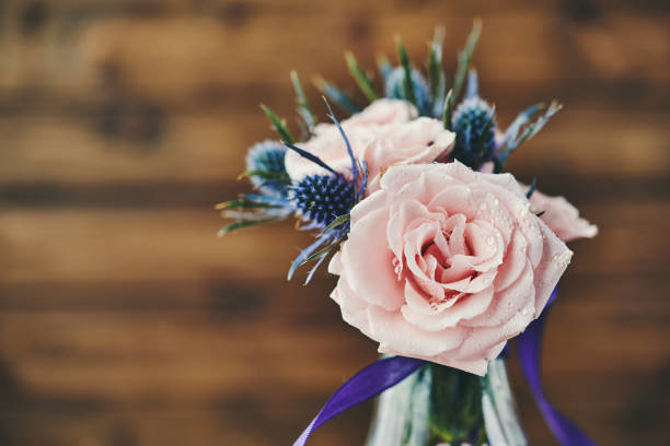 Mother's Day bouquet with pink roses in rustic setting Mother's Day bouquet with pink roses in rustic setting mothers day horizontal close up flower head stock pictures, royalty-free photos & images