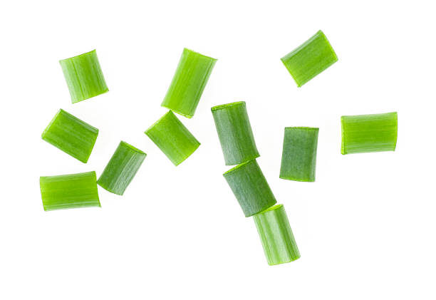istock Chopped fresh green onions isolated on white background. Top view. 945978068
