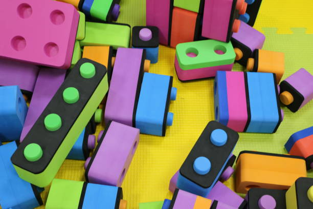 istock Children's constructor. Big pile plastic toy blocks.  Background of bright plastic big building blocks. Children's multicolor soft designer. Puzzle 945978360