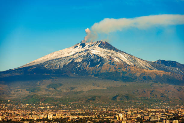 Mount Etna Volcano and Catania city - Sicily island Italy The mount Etna Volcano with smoke and Silvestri craters in the Catania city, Sicily island, Italy (Sicilia, Italia) Europe mt etna stock pictures, royalty-free photos & images