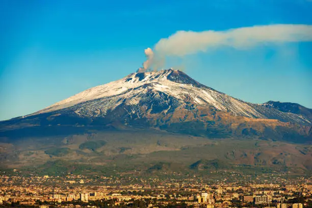 The mount Etna Volcano with smoke and Silvestri craters in the Catania city, Sicily island, Italy (Sicilia, Italia) Europe