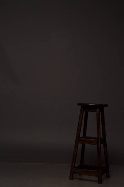 istock a brown chair stands on a gray background 945988976