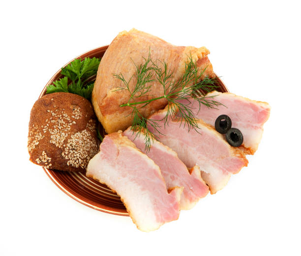 istock Smoked salted bacon with greens. On a white background. 945995294