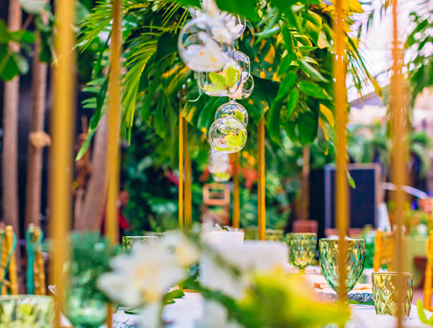 istock Orchids in hanging on threads glass pots at a tropical party 945995882