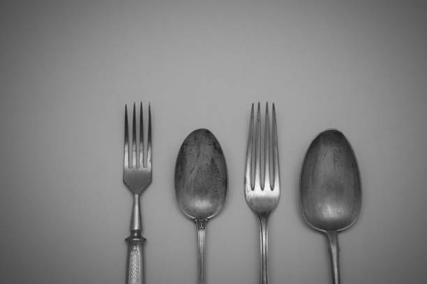 istock Vintage cutlery forks and spoons on an black  background 945996152