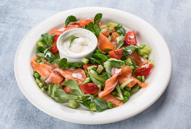 istock Vegetable salad with salmon and sauce. 945996518