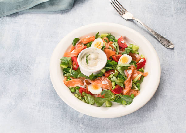 istock Vegetable salad with salmon and sauce. 945996556
