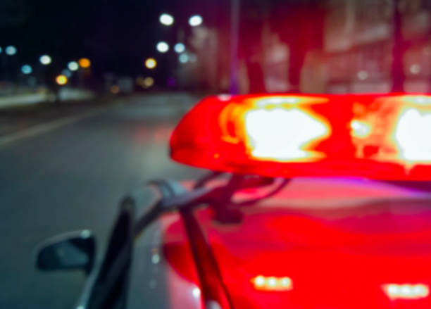 Police car red lights in night time, crime scene, night patrolling the city. Abstract blurry image. Police car lights in night time, crime scene, night patrolling the city. Abstract blurry image. police and firemen stock pictures, royalty-free photos & images