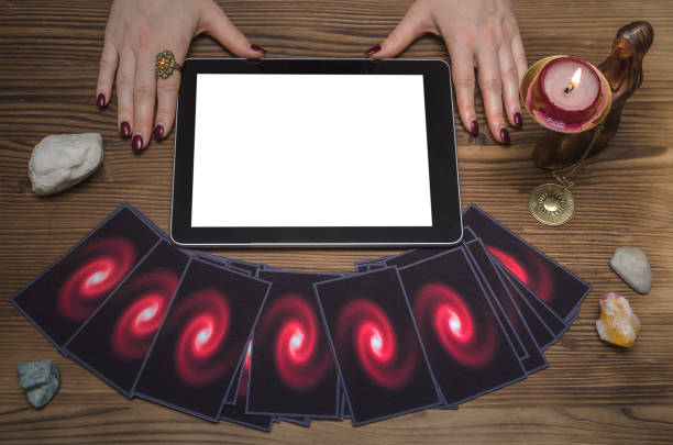 istock Tarot cards on fortune teller desk table. Online internet divination mock up. 946000420