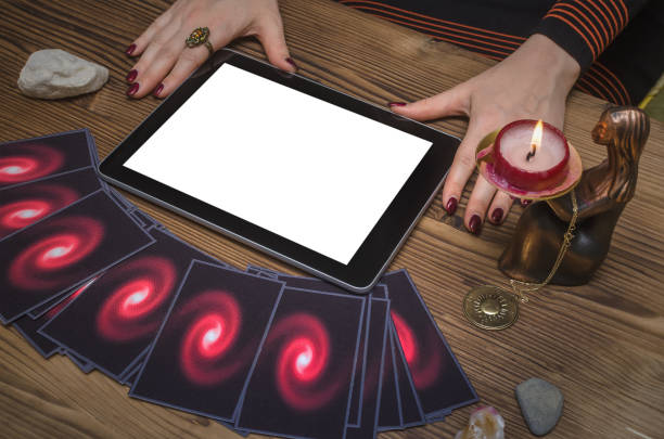 istock Tarot cards on fortune teller desk table. Online internet divination mock up. 946000460