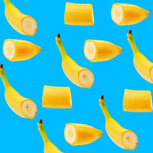 istock Banana slice pattern on pastel blue background. Minimal fruit concept. 946000466