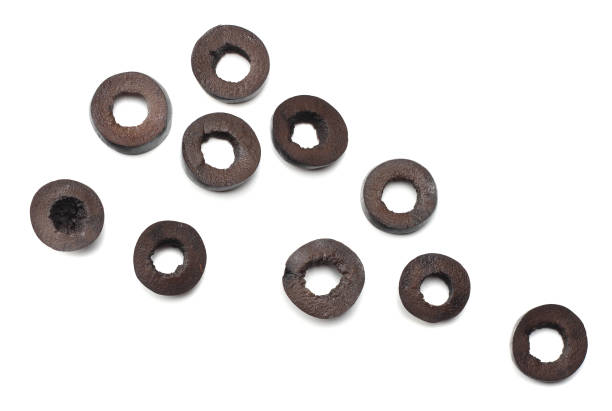 istock Marinated slices black olives isolated on white background. top view 946001406