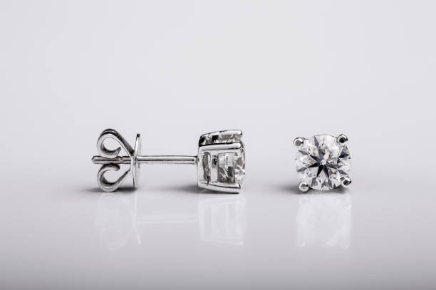 Pair of Diamond and white gold stud earrings on white background