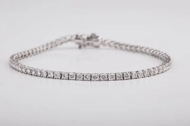Close up shot of beautiful diamond bracelets on white background