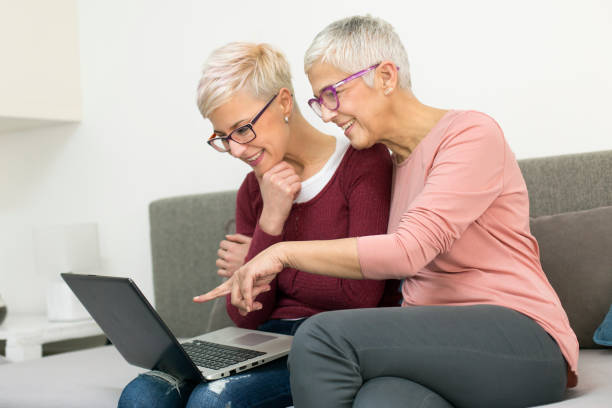 istock Mother and daughter looking at a laptop 946001746