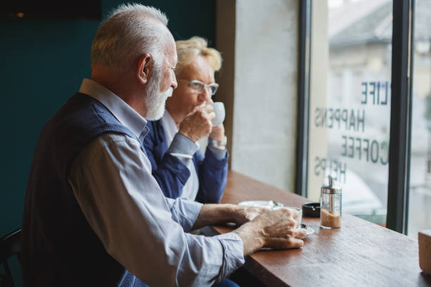 istock Senior couple drinking coffee at the bar 946008440