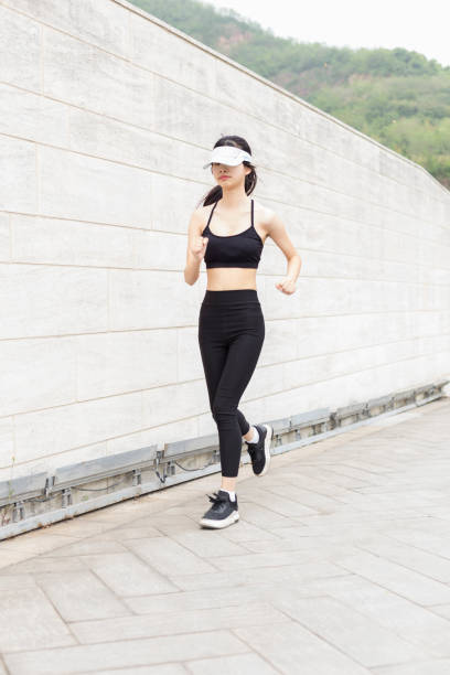 istock woman running in city 946008754