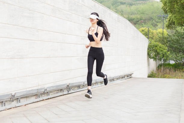 istock woman running in city 946008756