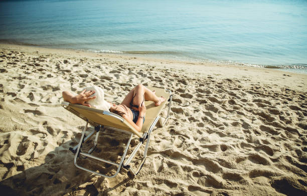 istock Girl on Sunbed at the Seaside 946008802